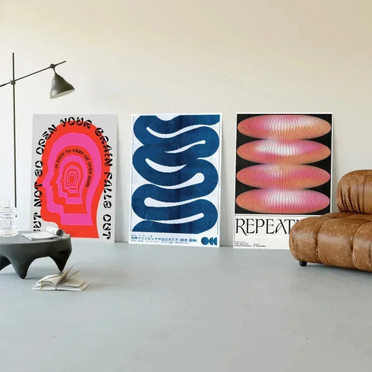 Three Abstract Canvas Wall Posters™ leaning against a wall, showcasing colorful abstract designs ideal for contemporary living room decoration.